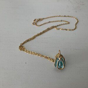 Blue topaz caged in solid gold and 14k solid gold 18" chain